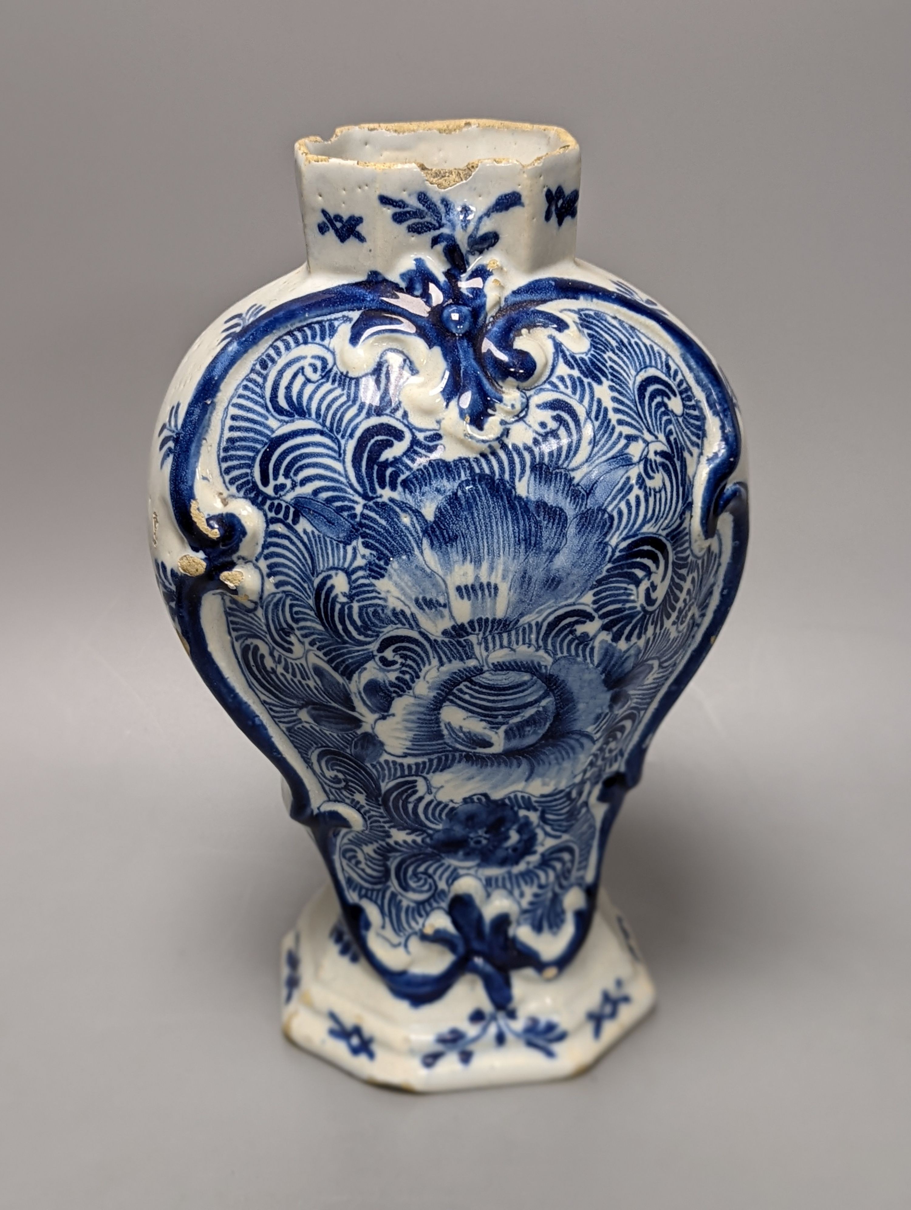 Four items of early 19th century blue and white pearlware pottery, an 18th century Delft blue and white vase and a 19th century toothbrush holder, Delft vase 22 cms high.